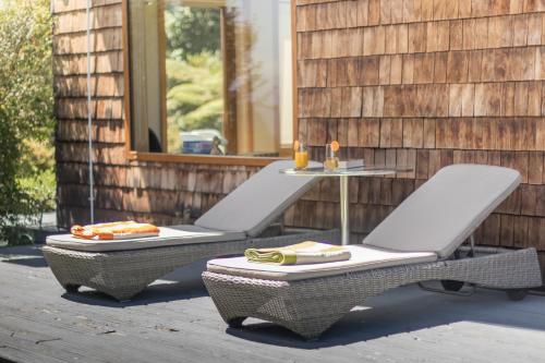two wicker chairs and a table on a patio at B&B Puerto Varas Playa Venado in Puerto Varas