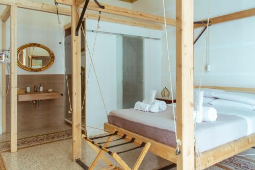 ein Schlafzimmer mit einem Schaukelbett und einem Spiegel in der Unterkunft Artisan Maison in Palermo