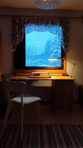 a computer monitor sitting on a desk in front of a window at Le Paradis Blanc Sauna & Spa in Kortetniemi