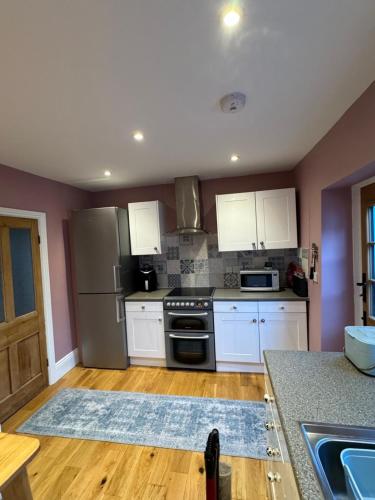 Η κουζίνα ή μικρή κουζίνα στο Caretaker’s Cottage