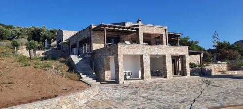 a large brick house on top of a hill at Borgo Thassos in Astris