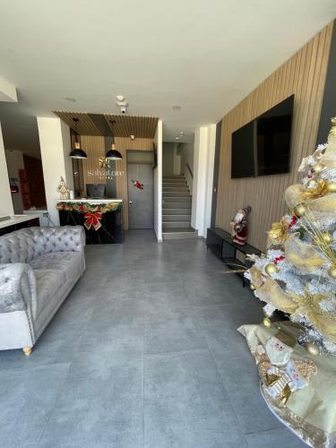 a living room with a couch and a christmas tree at HOTEL SALVATORE in Paipa