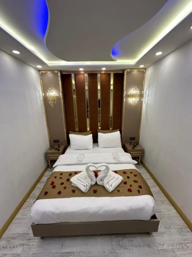 a bedroom with a bed with two towels on it at Moonlight Suit Hotel Taksim in Istanbul
