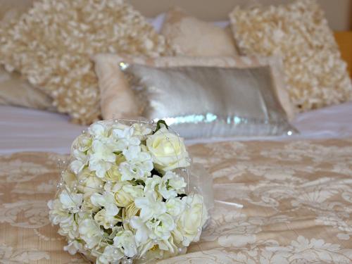 a bouquet of white flowers on a bed at Green Isle Hotel, Dublin in Clondalkin 