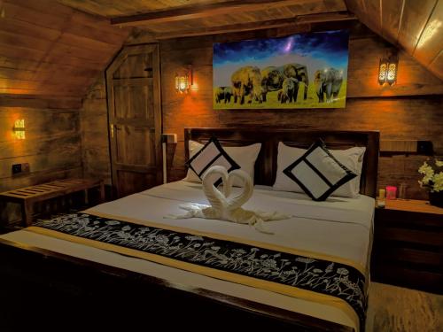 a bedroom with a bed with a peace sign on it at Levona Garden Resort in Habarana