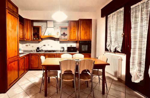 een keuken met een houten tafel en stoelen bij Casa Giulia in Santa Giulia