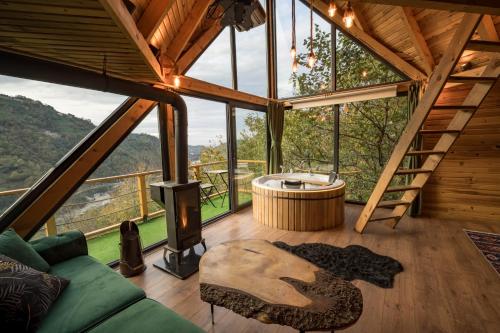 a tree house with a tub in the middle of a room at Pavri suit bungalov in Ardeşen