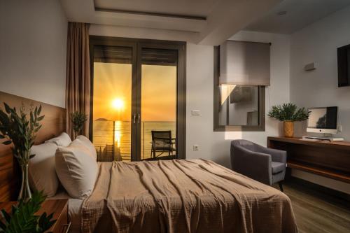 a bedroom with a bed and a desk and a television at Violet Beach Front Private Villa in Laganas