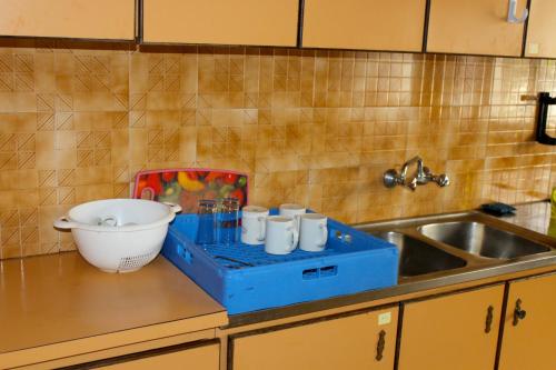 a kitchen counter with a mixer next to a sink at St Andrew's Guesthouse - Ramallah in Ramallah