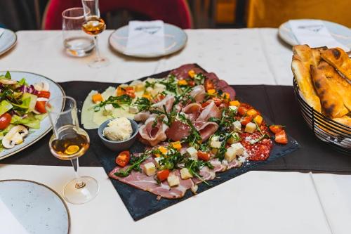 a table with a plate of food on a table at NLux 11 Apartment in Kopaonik