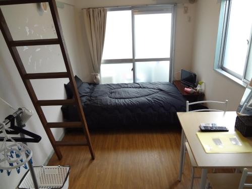 a bedroom with a bunk bed and a ladder at Vintage III - Vacation STAY 14908 in Fukuoka
