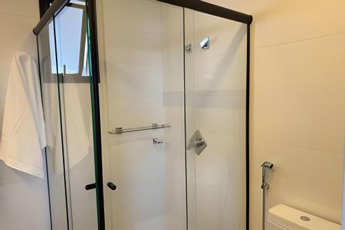 a shower with glass doors in a bathroom at Vertigo 243 - Gestão FGibran. in Campo Grande