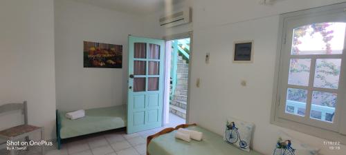 a room with a room with a door and a window at MENTA APT in Agia Pelagia