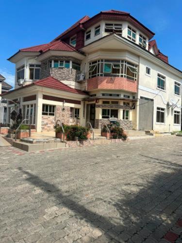 a large house sitting on top of a street at URBAN CASTLE SUITES Gwarimpa in Abuja