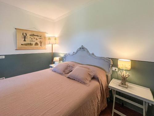 a bedroom with a large bed with two lamps at Casa Le Agavi in Portoferraio