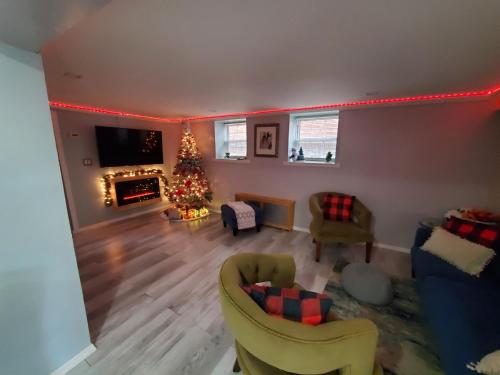a living room with a christmas tree in the corner at Lovely 2 bedroom Apartment with 2 Entrance and Parking in University Heights