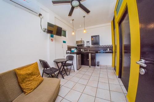 a living room with a couch and a table with chairs at Hotel Suites Nadia Puerto Vallarta in Puerto Vallarta