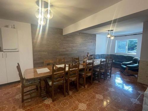 a dining room with a table and chairs at Casa Valea Gilortului in Ranca