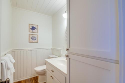 a white bathroom with a toilet and a sink at Scenic Bandon Vacation Rental with Beach Access! in Bandon
