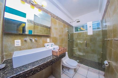 a bathroom with a sink and a toilet and a shower at Hotel Suites Nadia Puerto Vallarta in Puerto Vallarta