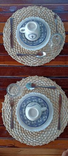 una tavola con piatti e posate blu e bianchi di Odoyá Corumbau a Corumbau