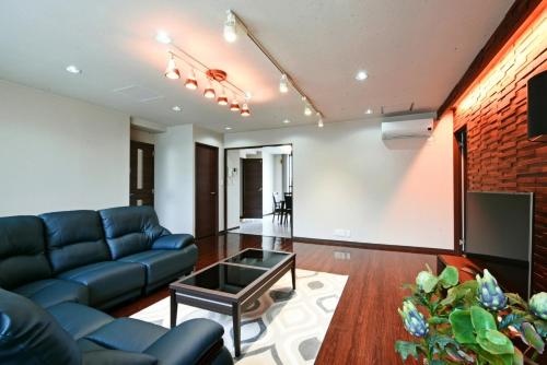 a living room with a couch and a tv at Pleasure Maruyama - Vacation STAY 52754v in Sapporo