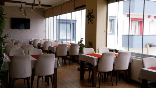 a conference room with tables and chairs and windows at Hotel Labella Bergama in Bergama