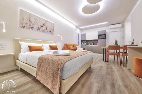 a bedroom with a large bed and a kitchen at FORESTERIA GUESTHOUSE CA' DEI BACHITT in Lierna