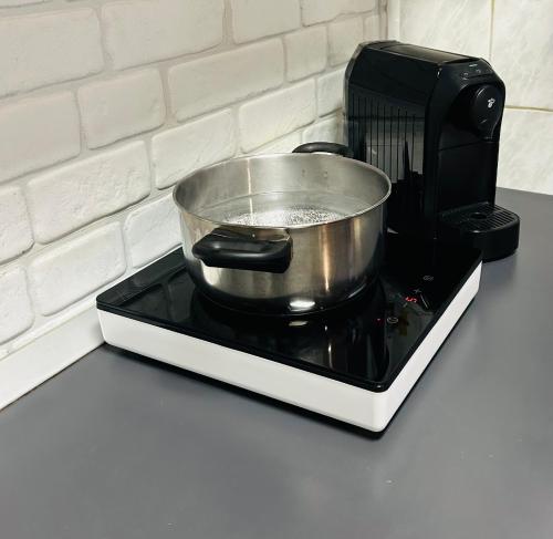 a pot sitting on top of a stove at Henriett’s cosy places in Satu Mare
