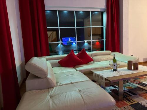 a living room with a white couch and a table at Romantic Lodge in Banja Luka