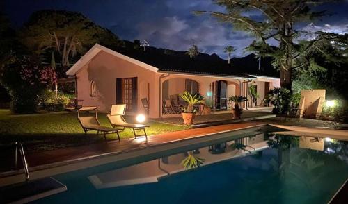 a house with a swimming pool at night at Casa Le Agavi in Portoferraio