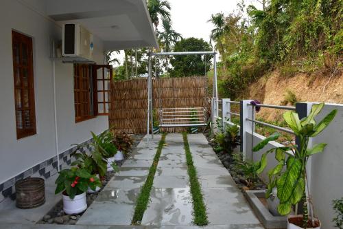 a garden with plants on a walkway at coco view in Port Blair