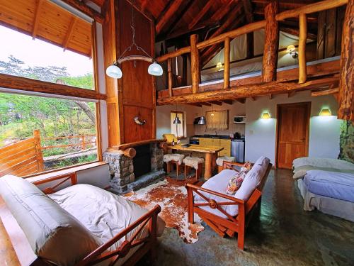 a living room with a couch and a fireplace at Patagonia Villa Lodge in Ushuaia