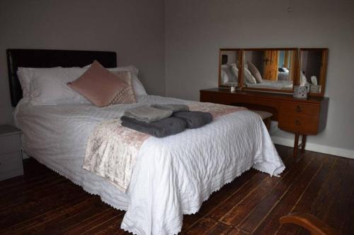 a bedroom with a bed with towels on it at North Coast country home(Portrush,Portstewart,Giant's Causeway) in Balnamore