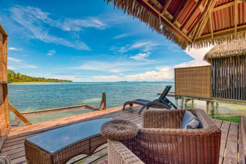 a deck with a hot tub and the ocean at Azul Over-the-Water Resort in Bocas Town