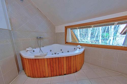 a bath tub in a bathroom with a window at Patagonia Villa Lodge in Ushuaia