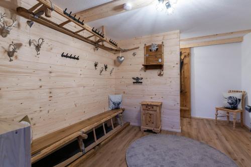 a room with a wooden wall with a bench at Kummererhof in Itter