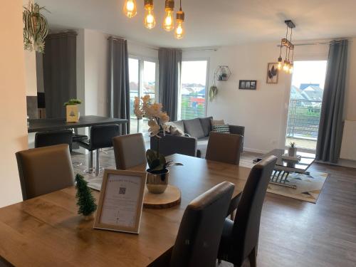 a dining room and living room with a table and chairs at LOVELY By Dream Apartments in Montévrain