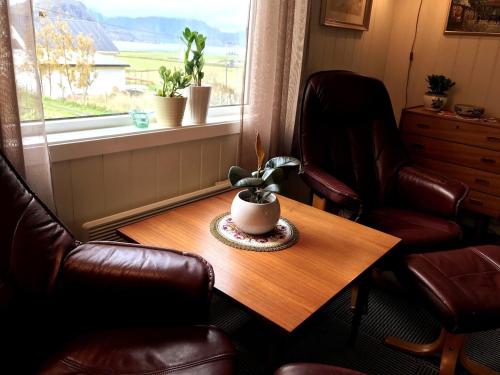 a room with a table and two chairs and a window at Haukland Beach House in Leknes