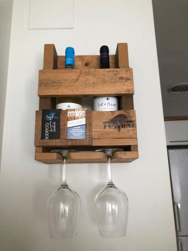 a wall mounted wine rack with wine glasses and wine bottles at Apartamento Migdia-Moraira in Moraira
