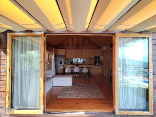 a living room with a door open to a living room at A Casa da Japoneira CB in Rebordões