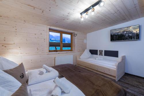 a bedroom with a large bed in a wooden room at Kummererhof in Itter