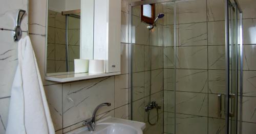 a bathroom with a shower and a sink and a mirror at Kaltur Boutique Hotel in Yalova