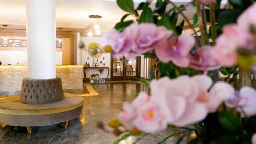 a lobby with a column and pink flowers at Hotel Labella Bergama in Bergama