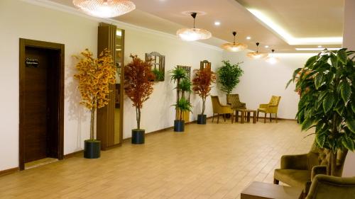 a lobby with potted plants and tables and chairs at Hotel Labella Bergama in Bergama