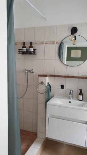 a bathroom with a sink and a mirror at Petite Maison de plage in Insel Poel