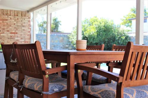 a wooden table and chairs on a patio at El Chuco Home W Pool, Pool Table,15 Min Downtown in El Paso