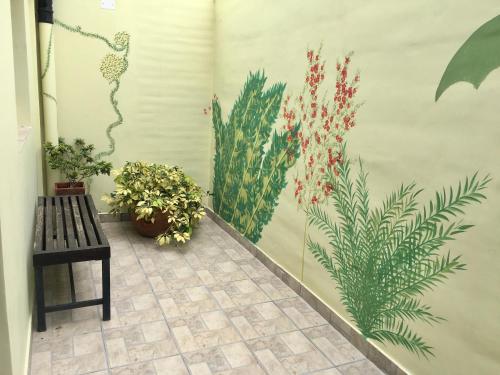 a mural of plants on a wall next to a bench at LOFT JUJUY, Alto Gorritti - Departamento cerca del Centro in San Salvador de Jujuy