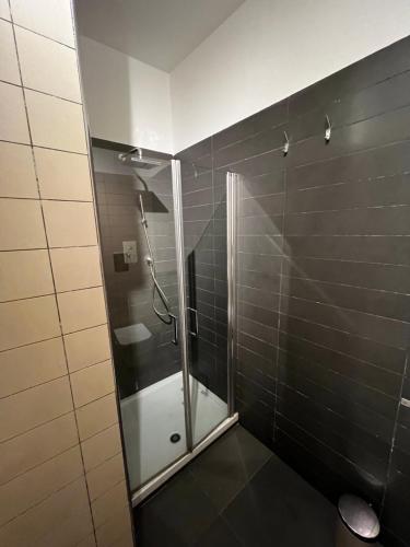 een douche met een glazen deur in de badkamer bij Arechi home in Salerno