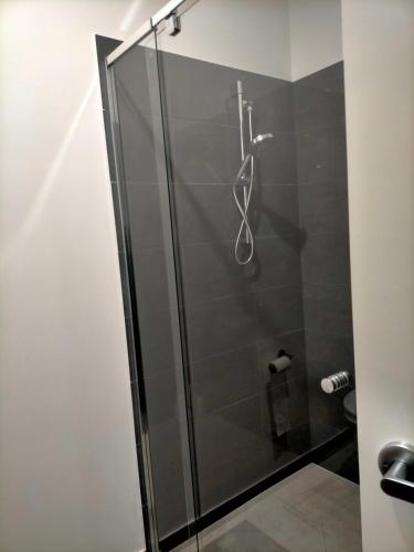 a shower with a glass door in a bathroom at Maha Melton Homestay in Melton South